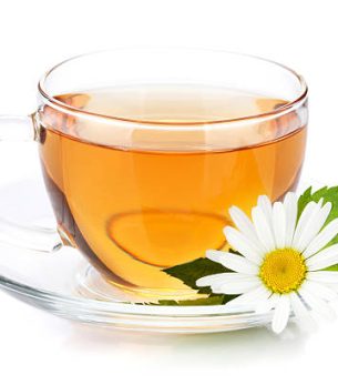 cup of tea with mint leaves and chamomile flower. isolated on white background
